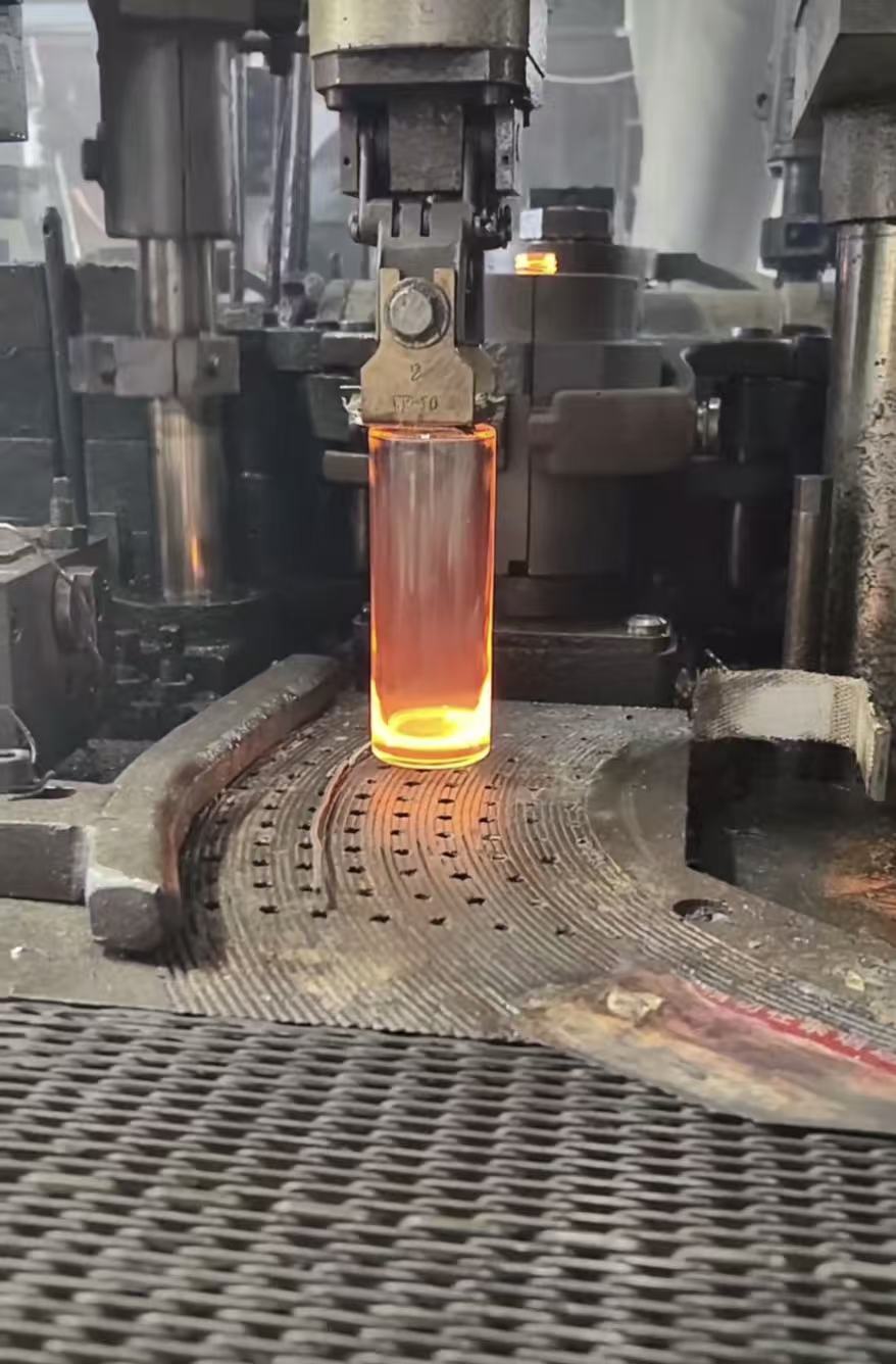 Molten glass perfume bottle being formed — orange glow, forming machine, Loci Glass Jiangxi factory