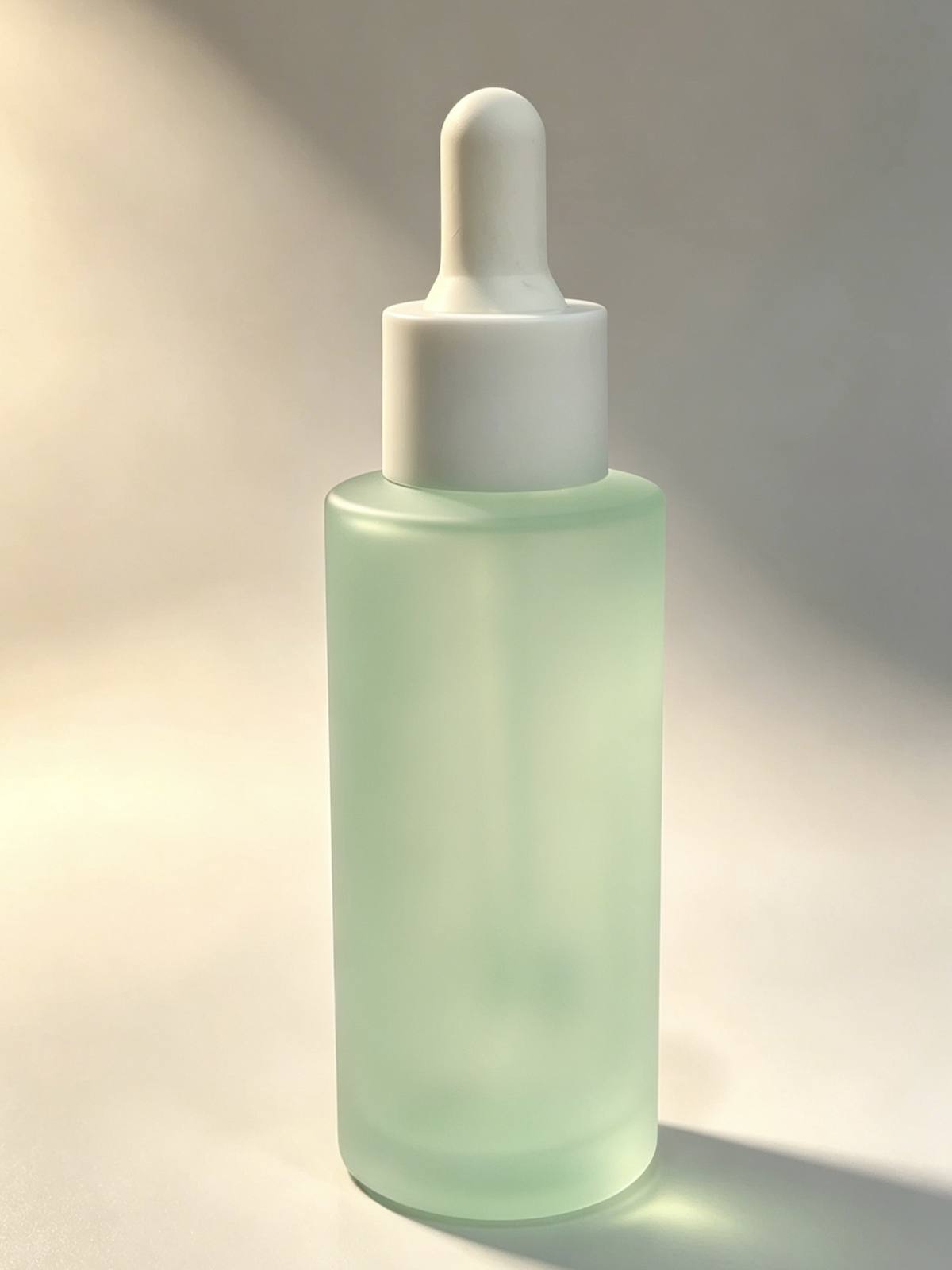 60ml round glass serum bottle wholesale OEM skincare packaging China factory dropper screw cap